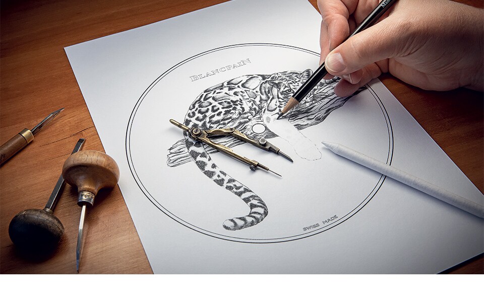 Tracing a sketch on paper of the motifs to be engraved.
